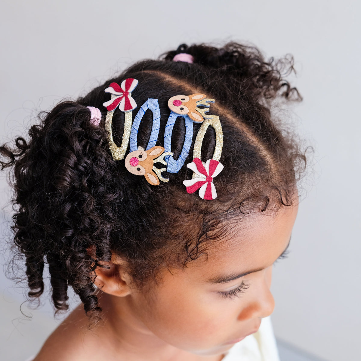 Young girl wearing Rudolph and Bow hair clips