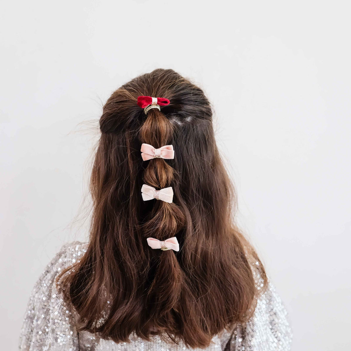 Young girl wearing glitter velvet bow hair ties