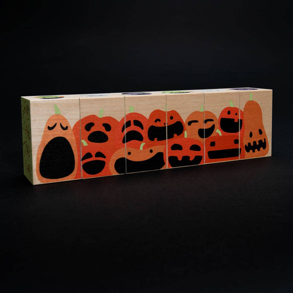 Close-up of Halloween wooden blocks showing a haunted house and staring eyeball illustrations