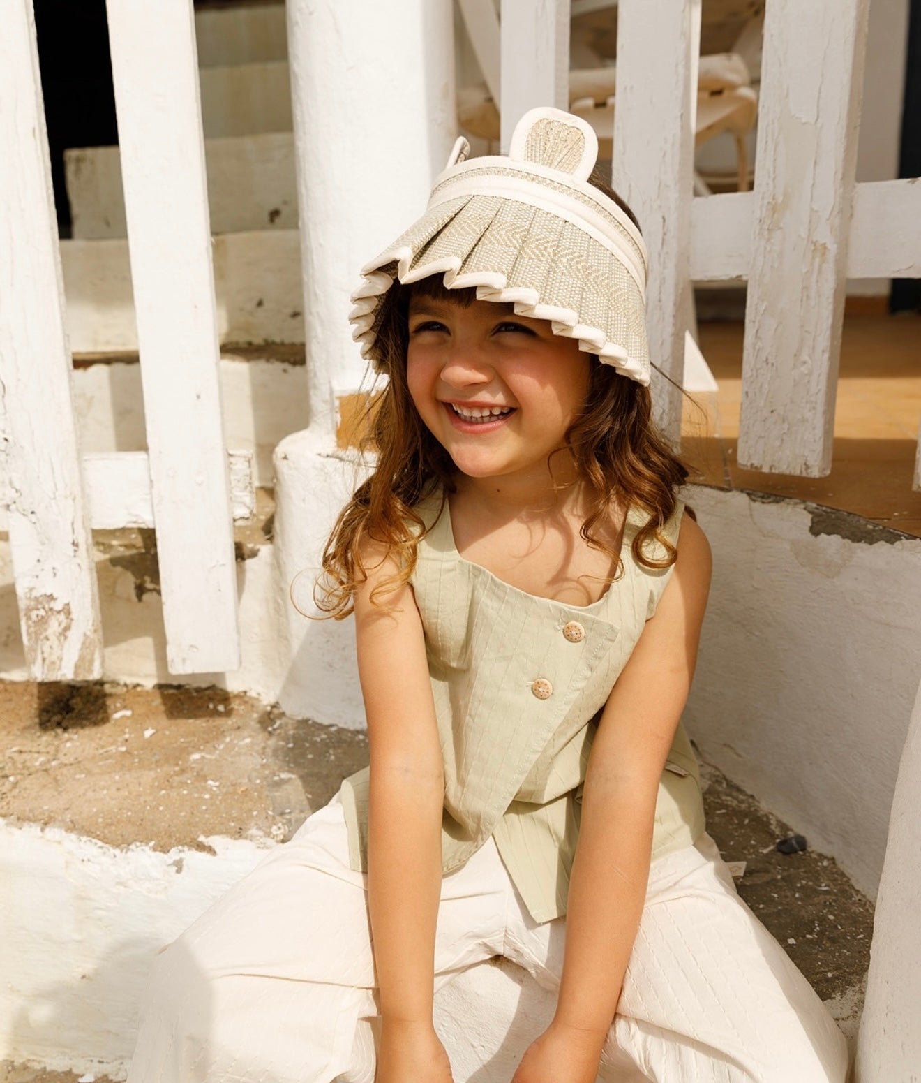 Close-up of child wearing LORNA MURRAY × OZOONZ ozbear sunvisor with bear ears