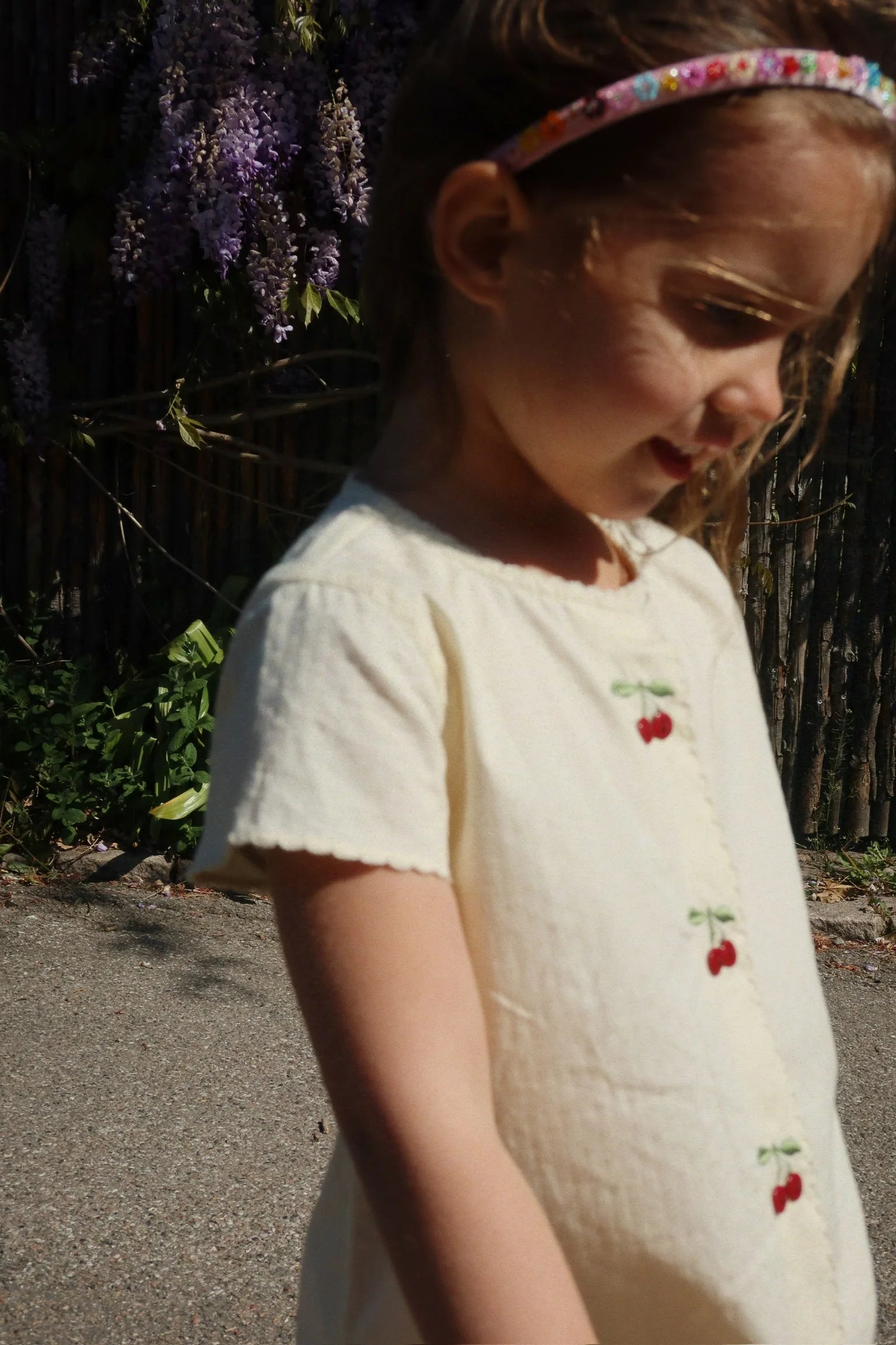 Toddler wearing Evia Cherry Dress by Konges Sløjd, comfortable summer baby dress