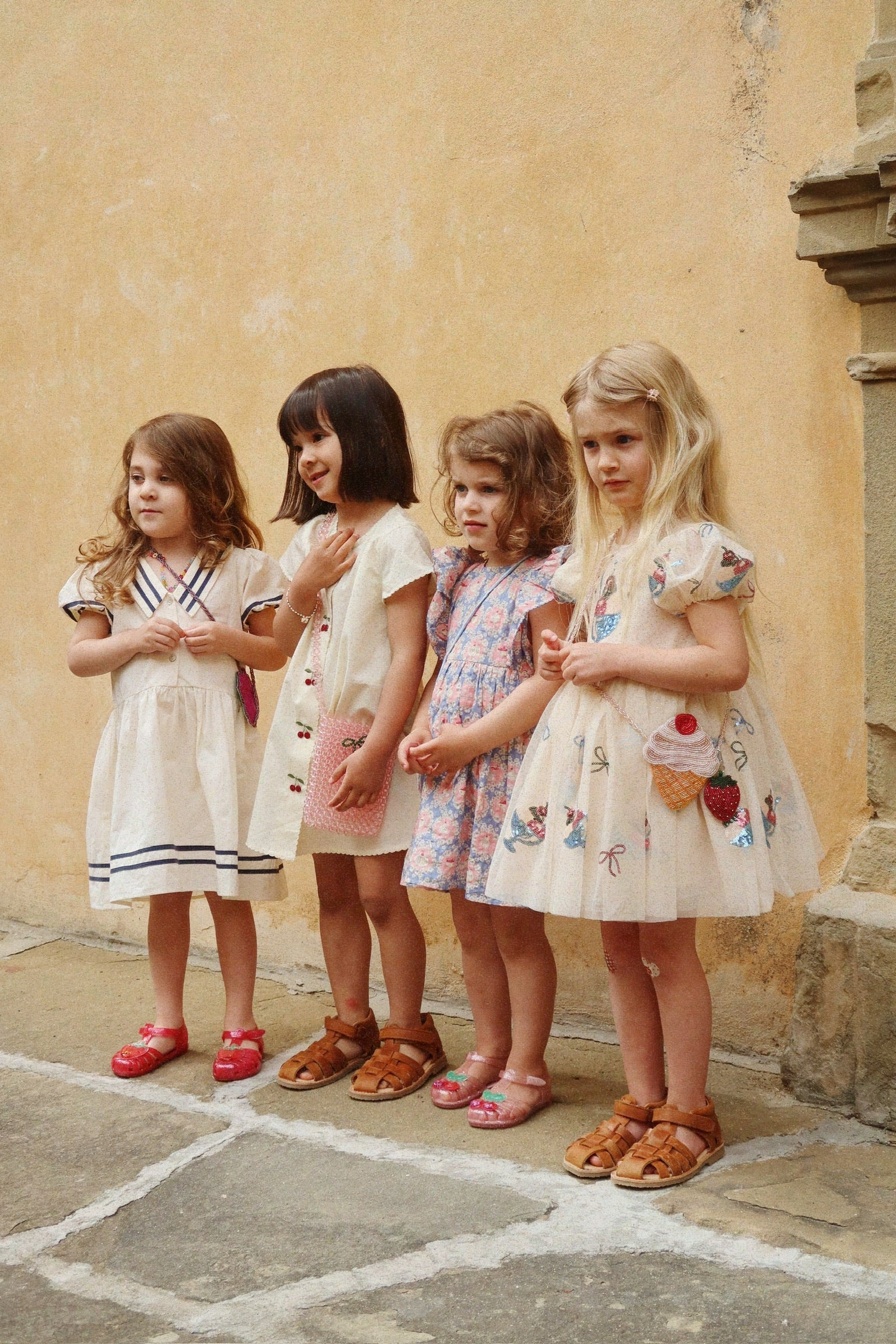 Children wearing Evia Cherry Dress by Konges Sløjd outdoors, matching toddler dresses with cherry print