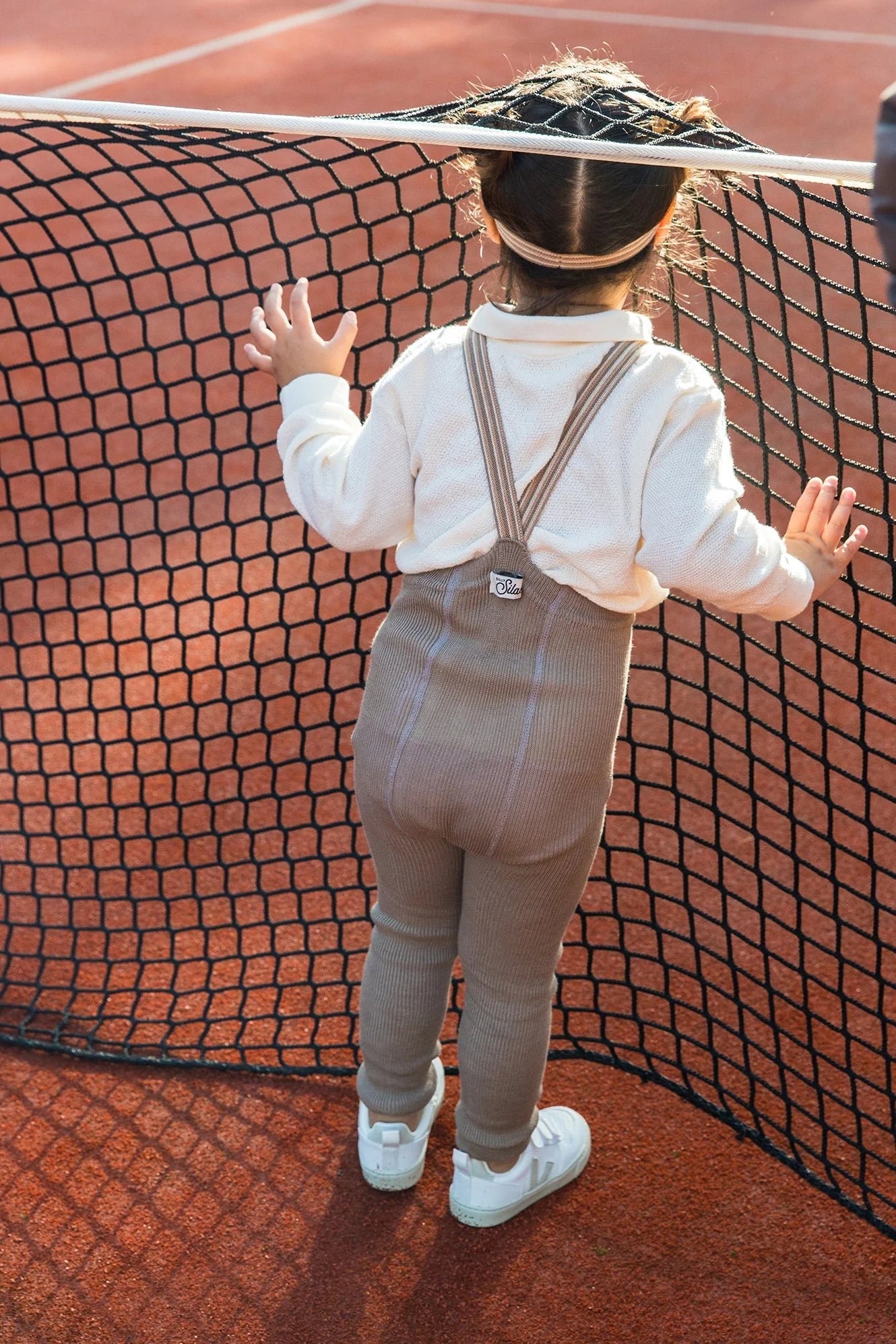 Back view of child wearing Silly Silas oyster grey striped suspender tights
