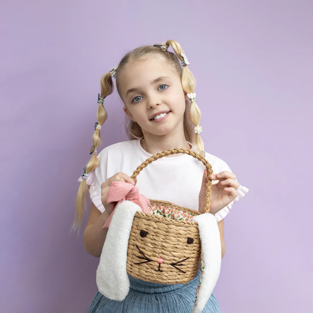 child holding Mimi and Lula bunny easter basket