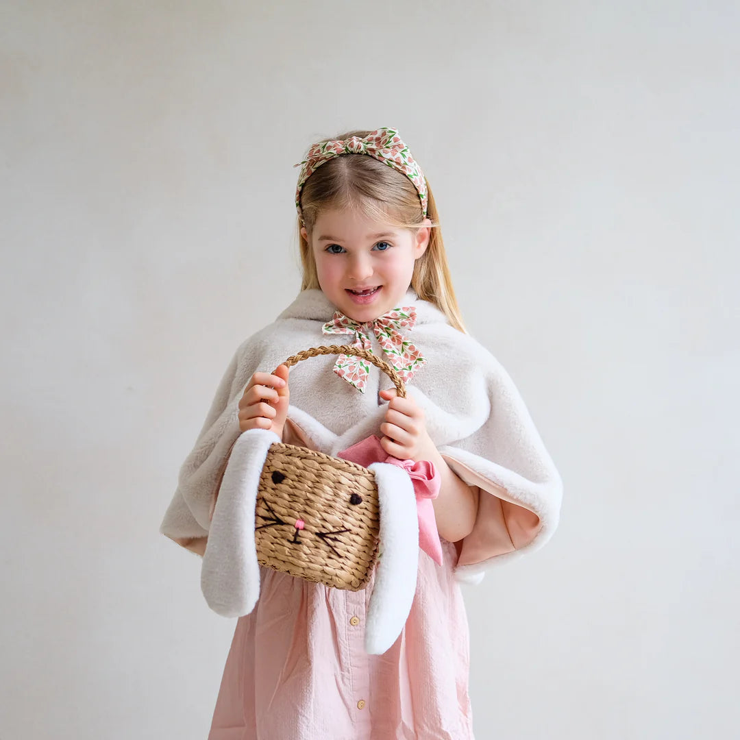child holding Mimi and Lula bunny easter basket