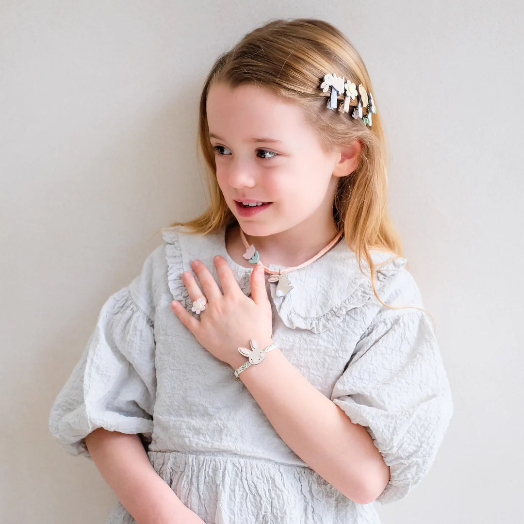 girl wearing Mimi and Lula bunny necklace and bracelet