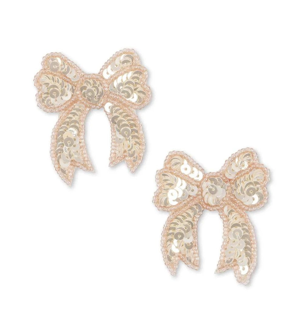 Close-up of Konges Sløjd white sequin bow hair clips for kids