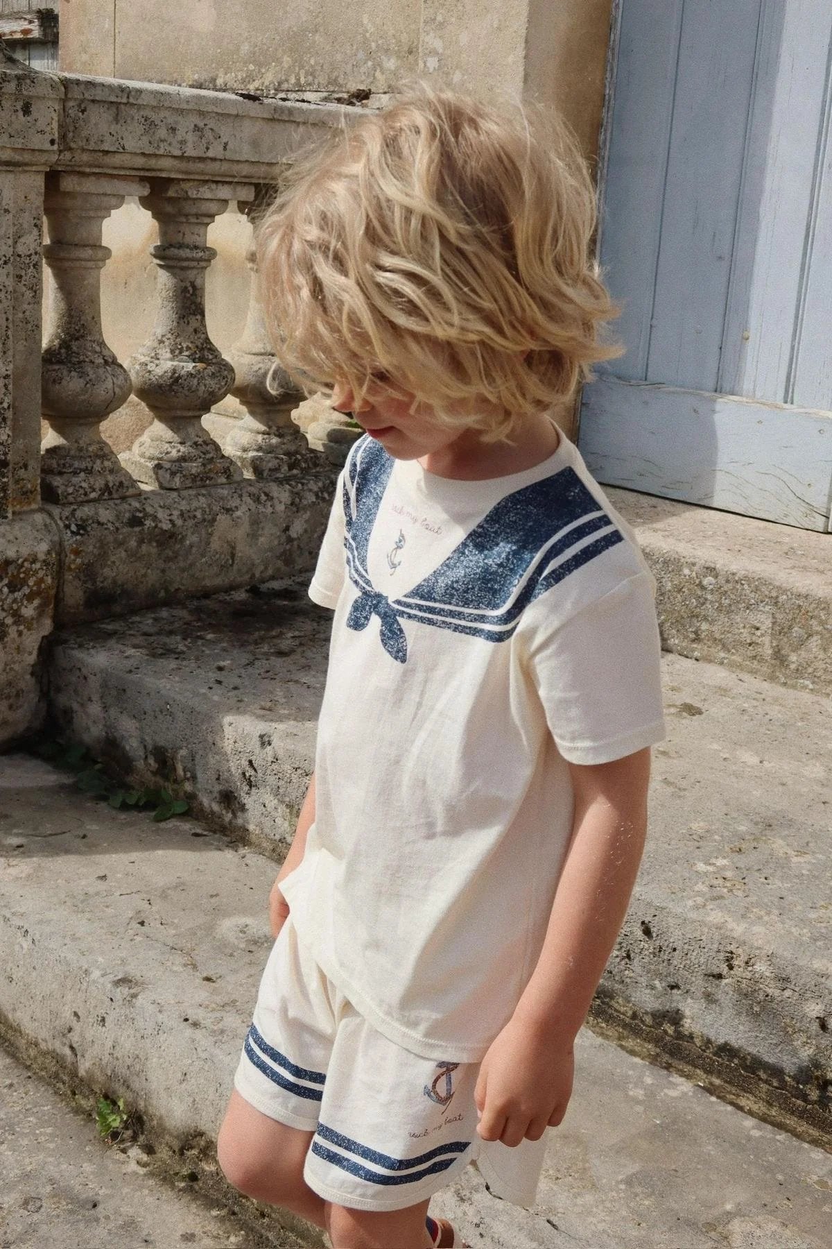 Child wearing Konges Sløjd Famo GOTS organic cotton baby and toddler set outdoors