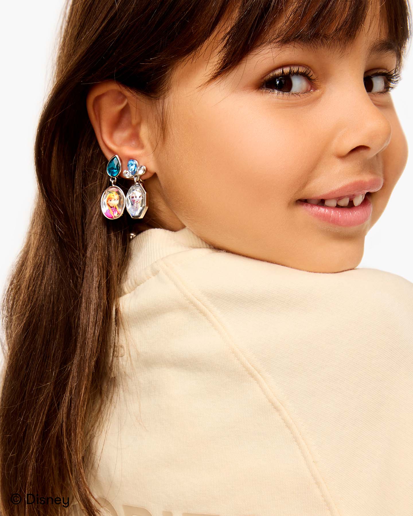 Child wearing earrings from Disney Frozen Earring Set