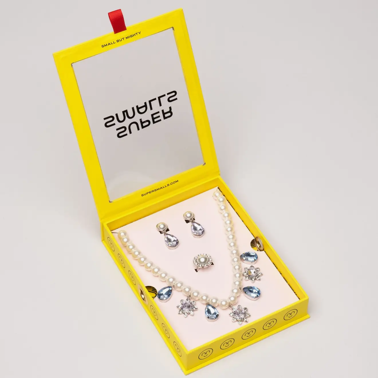 Super Smalls Pearled Gem Necklace Set displayed in yellow packaging with jewelry accessories