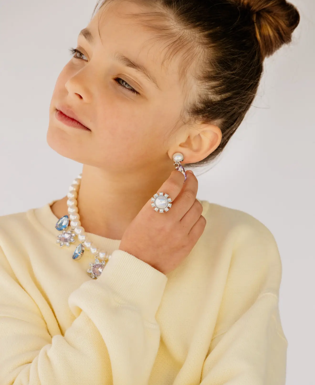 Child wearing Super Smalls Pearled Gem Necklace Set with pearl-inspired jewelry