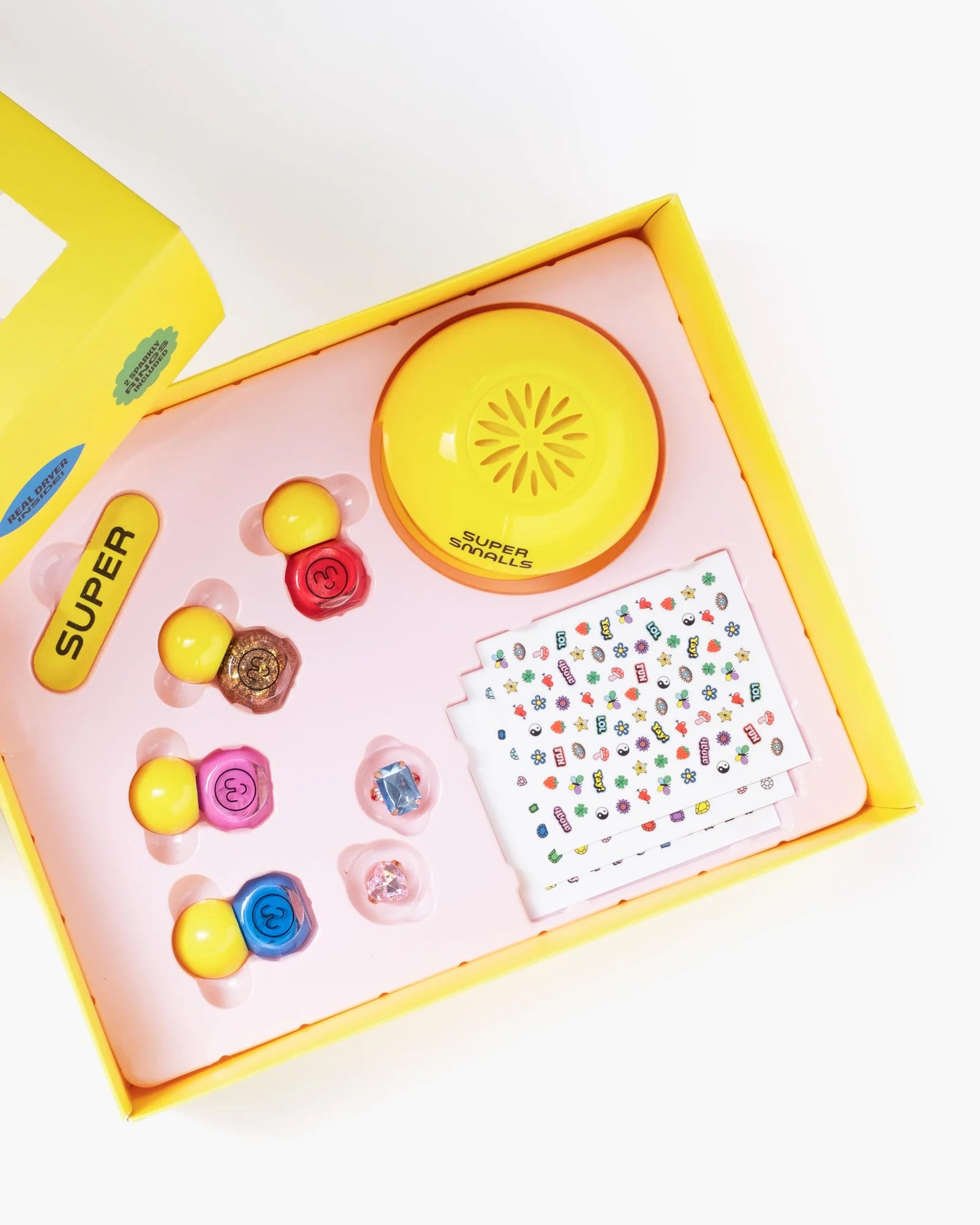 Super Smalls Self Care Nail Kit for kids with colorful nail accessories, stickers, and beauty play items in a yellow box
