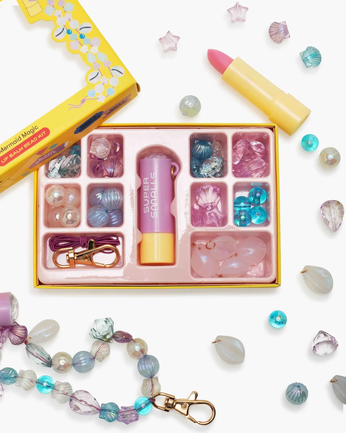 Supersmalls Mermaid Magic Lip Balm Bead Kit — kids DIY lip balm and bead jewellery making kit with mermaid theme, shown in yellow gift box with accessories