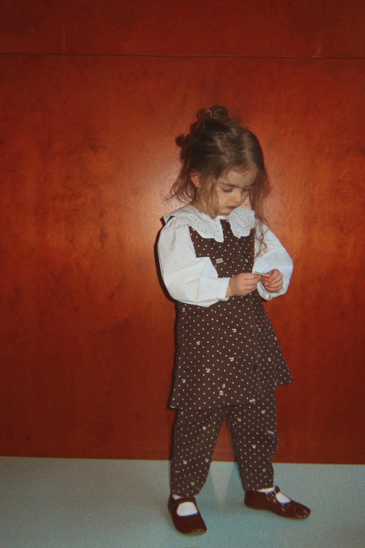 Toddler in the Cara dress with matching cherry-dot pants, full length