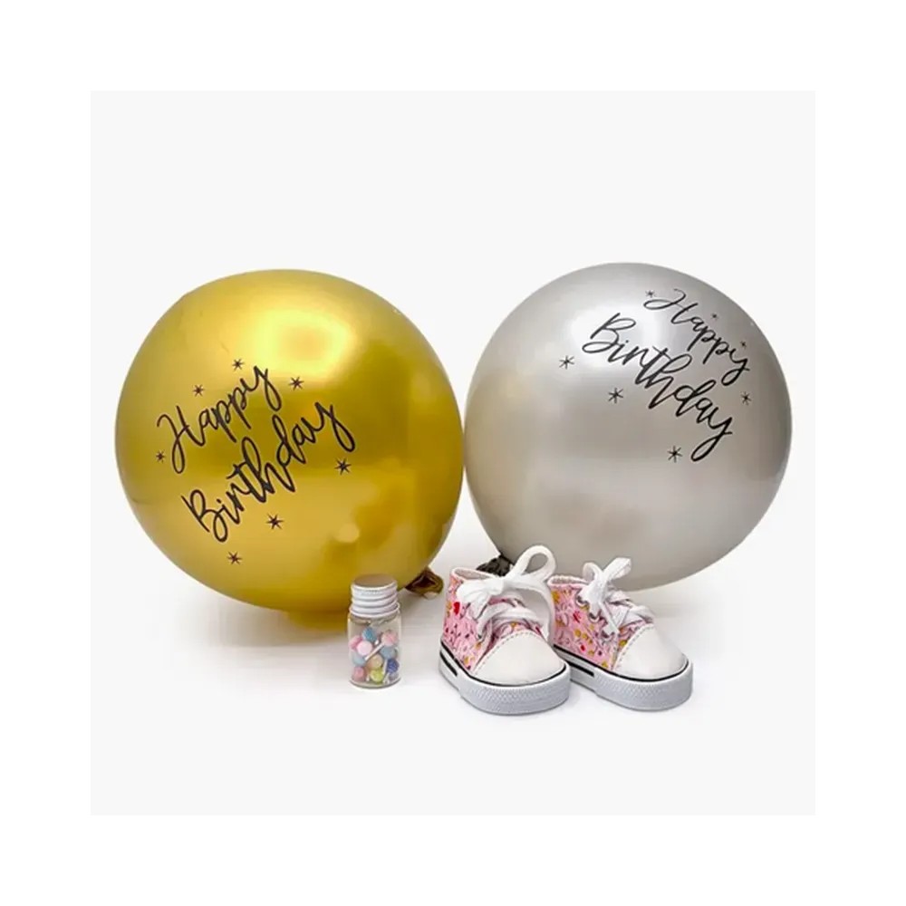 Mini Panchas birthday accessory set with pink floral Komvers sneakers, lollipop jar and Happy Birthday balloons by Minikane