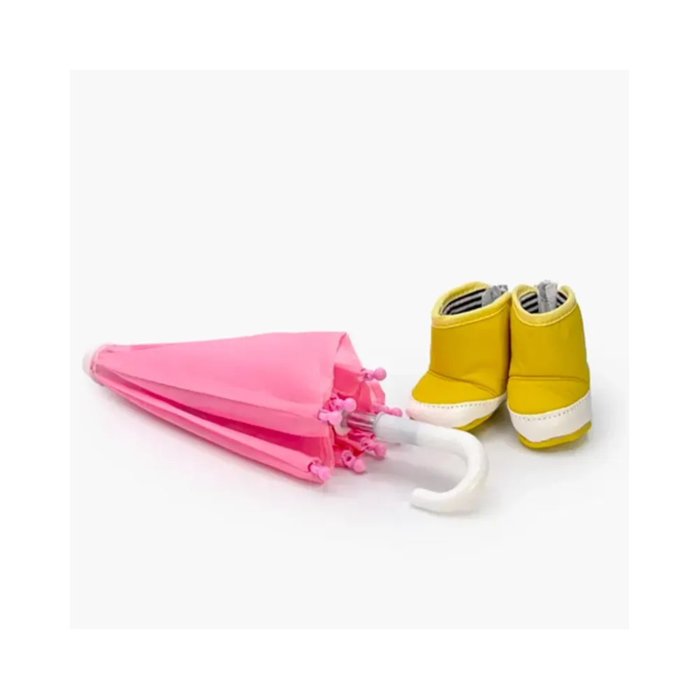 Mini Panchas rain accessory set with pink umbrella and yellow boots by Minikane