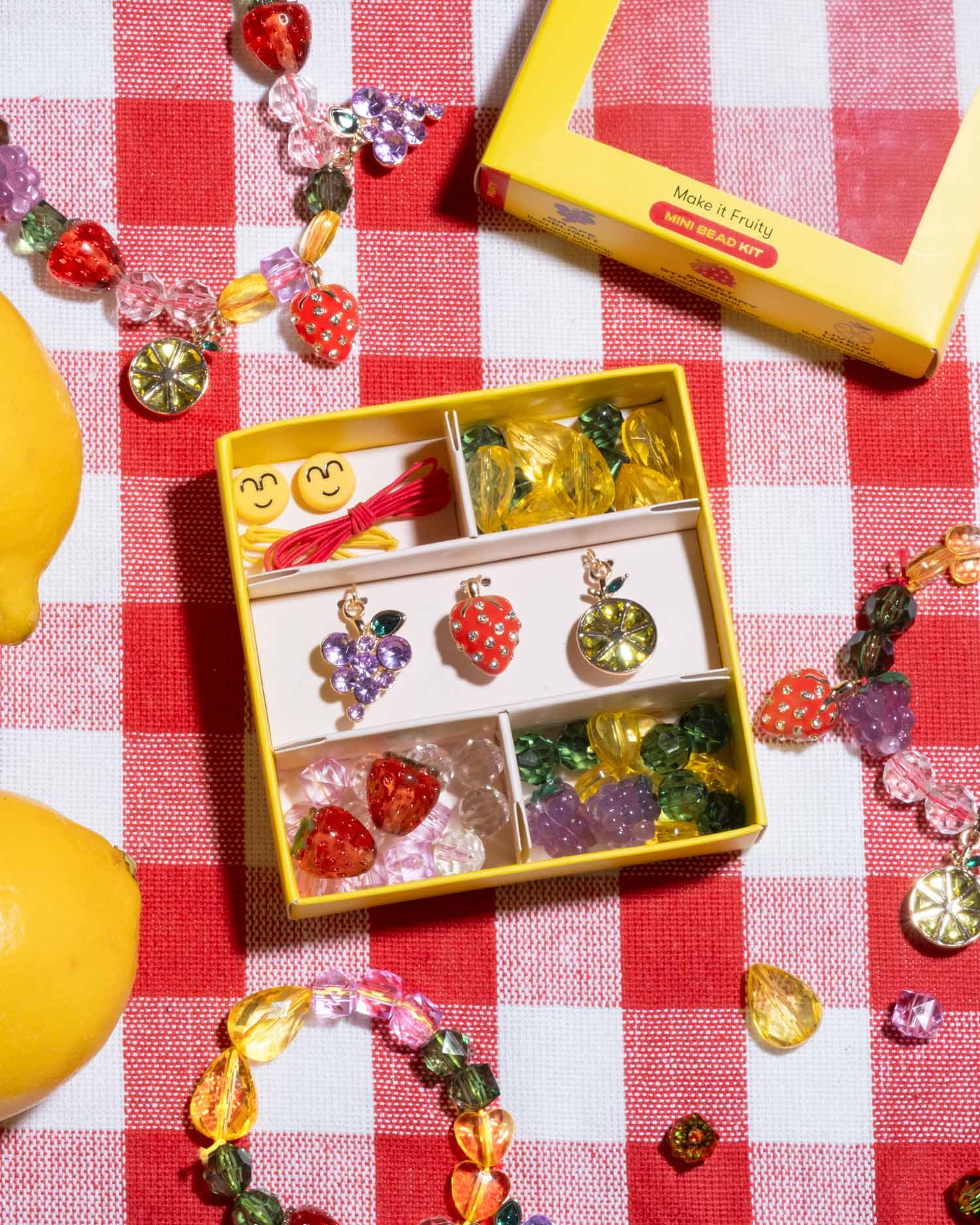 Super Smalls Make It Fruity Mini Bead Kit displayed with fruit-themed packaging and bead accessories
