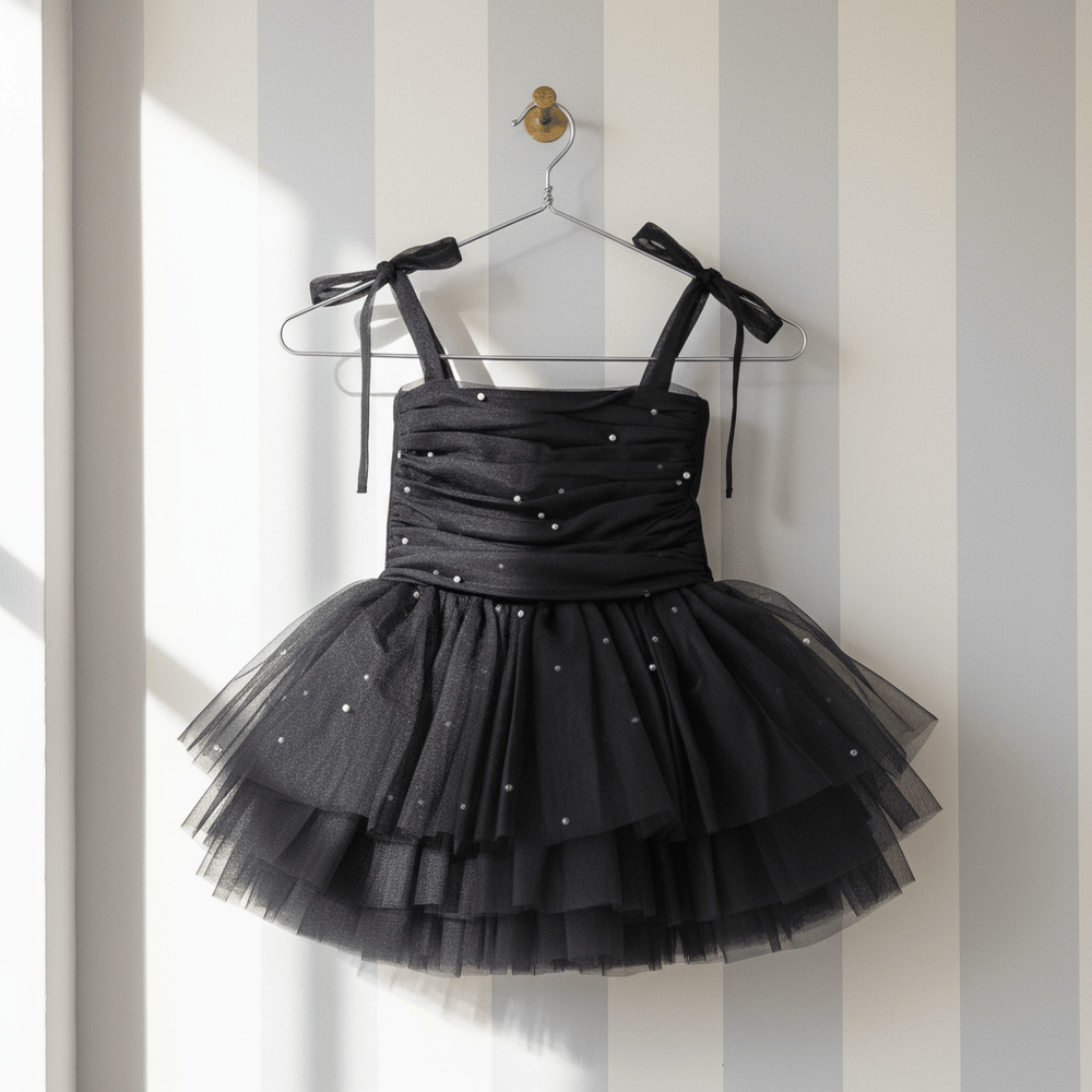 DOLLY by Le Petit Tom Pearl Tulle Ballerina Dress in Black — layers of pearl-adorned black tulle ballerina dress for girls, hanging on hanger