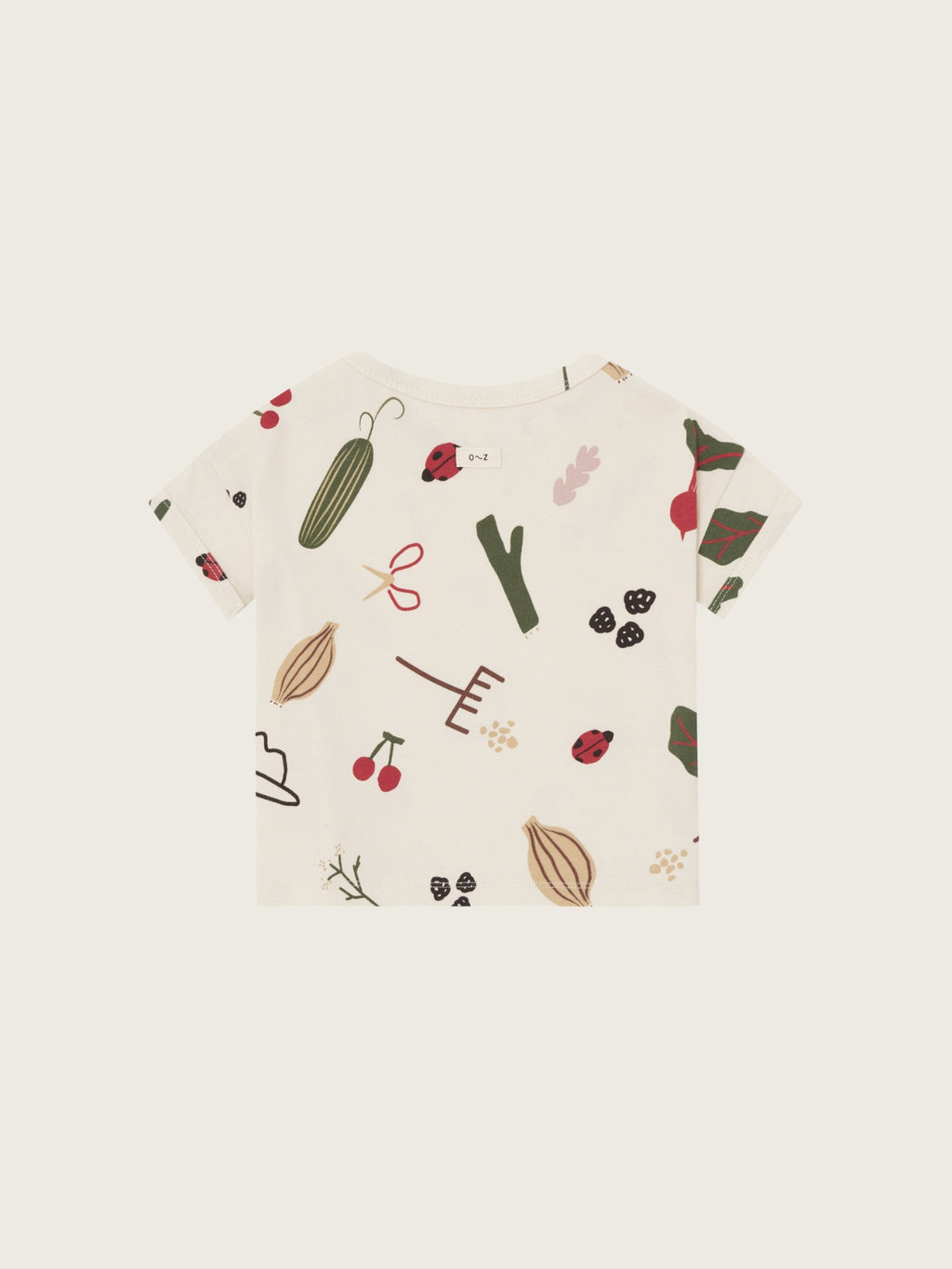 Organic Zoo Grow & Gather Boxy T-Shirt — cream organic cotton kids boxy tee with all-over hand-illustrated botanical and vegetable print, flat lay on cream background