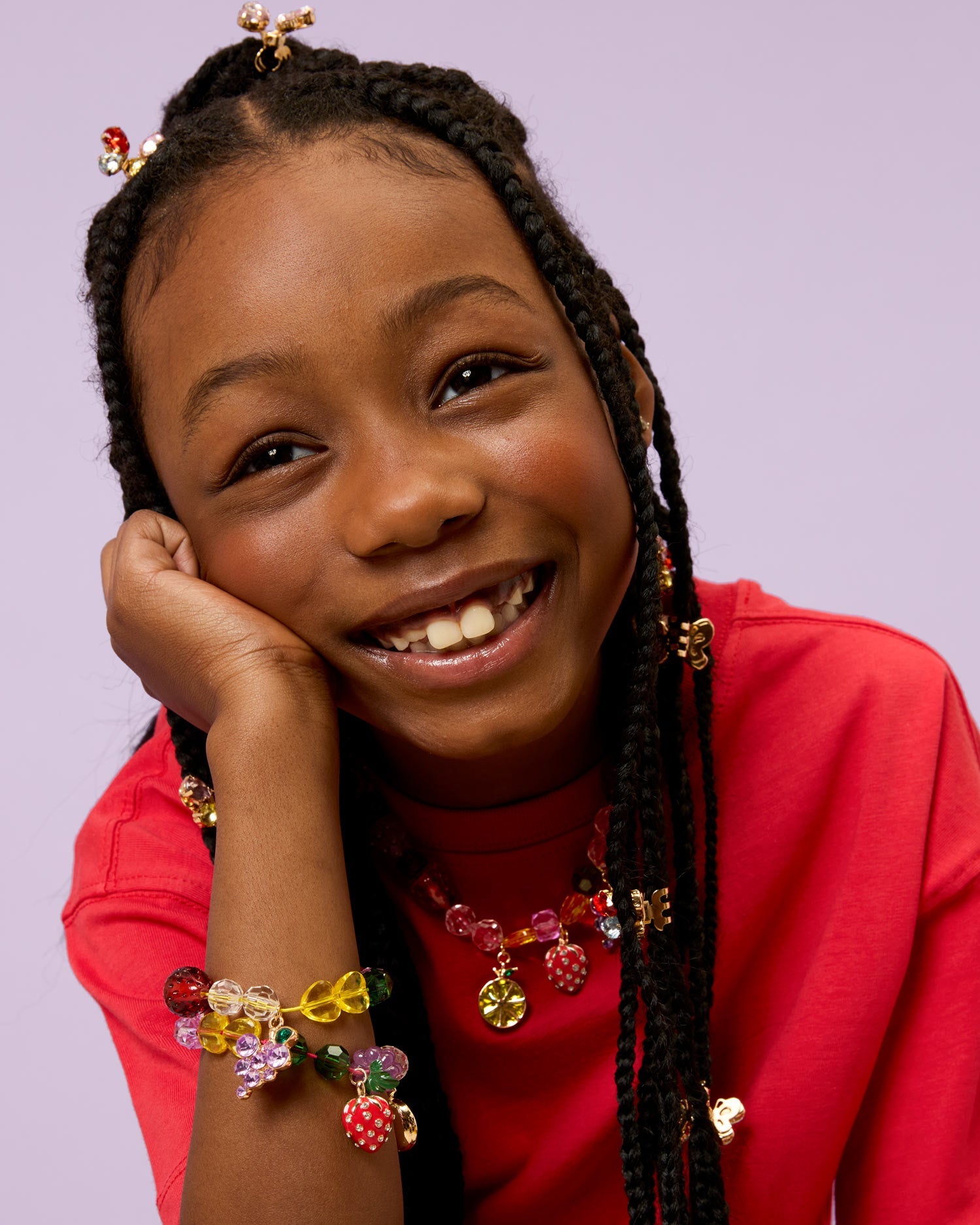 Child wearing jewelry made with Super Smalls Make It Fruity Mini Bead Kit