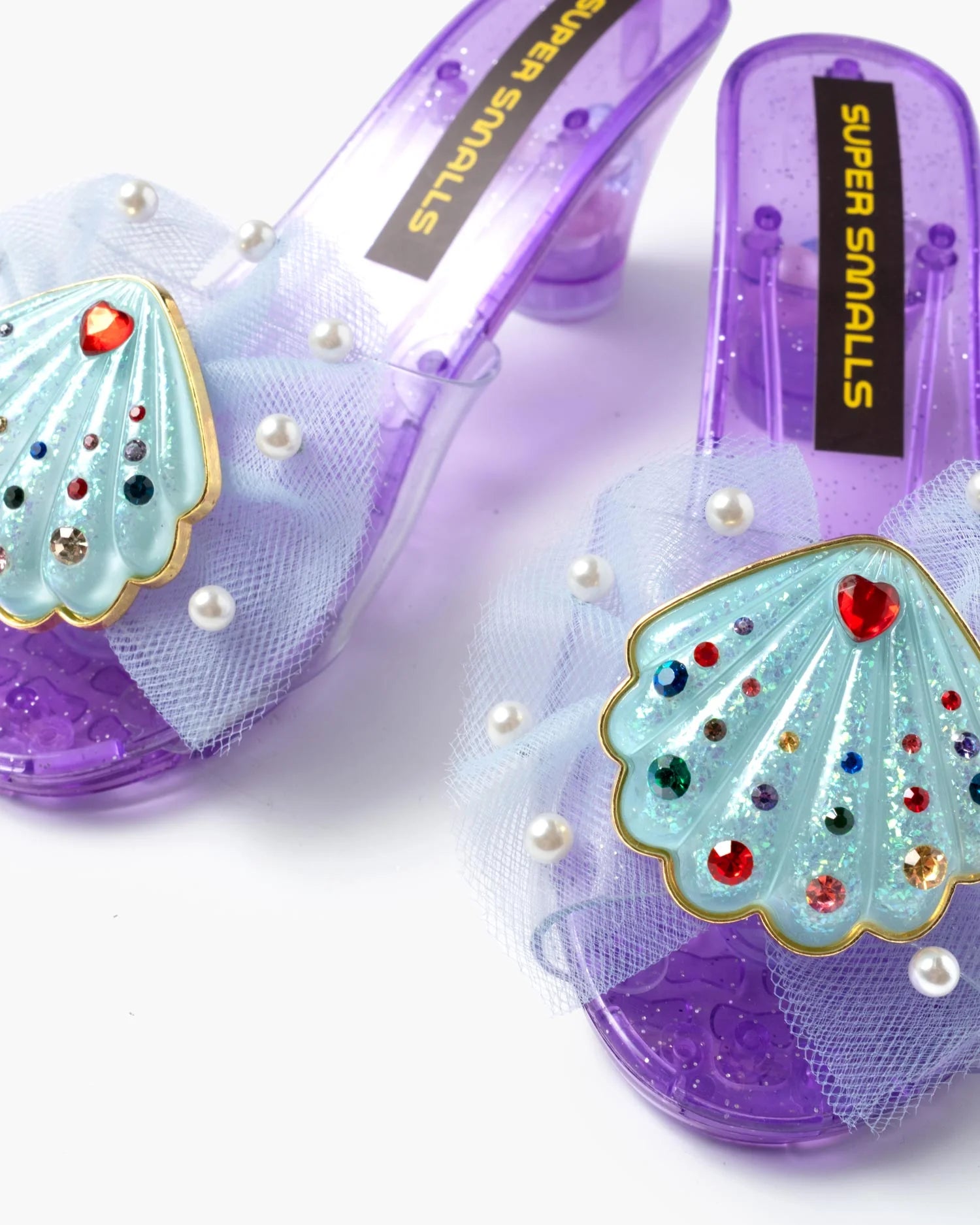 Close-up of Super Smalls Mermaid Dreams play shoes showing gem-filled shaker heels and seashell detail