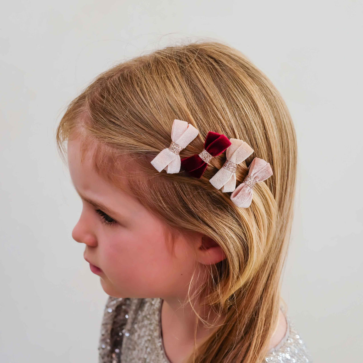 Young girl wearing glitter velvet bow salon hair clips