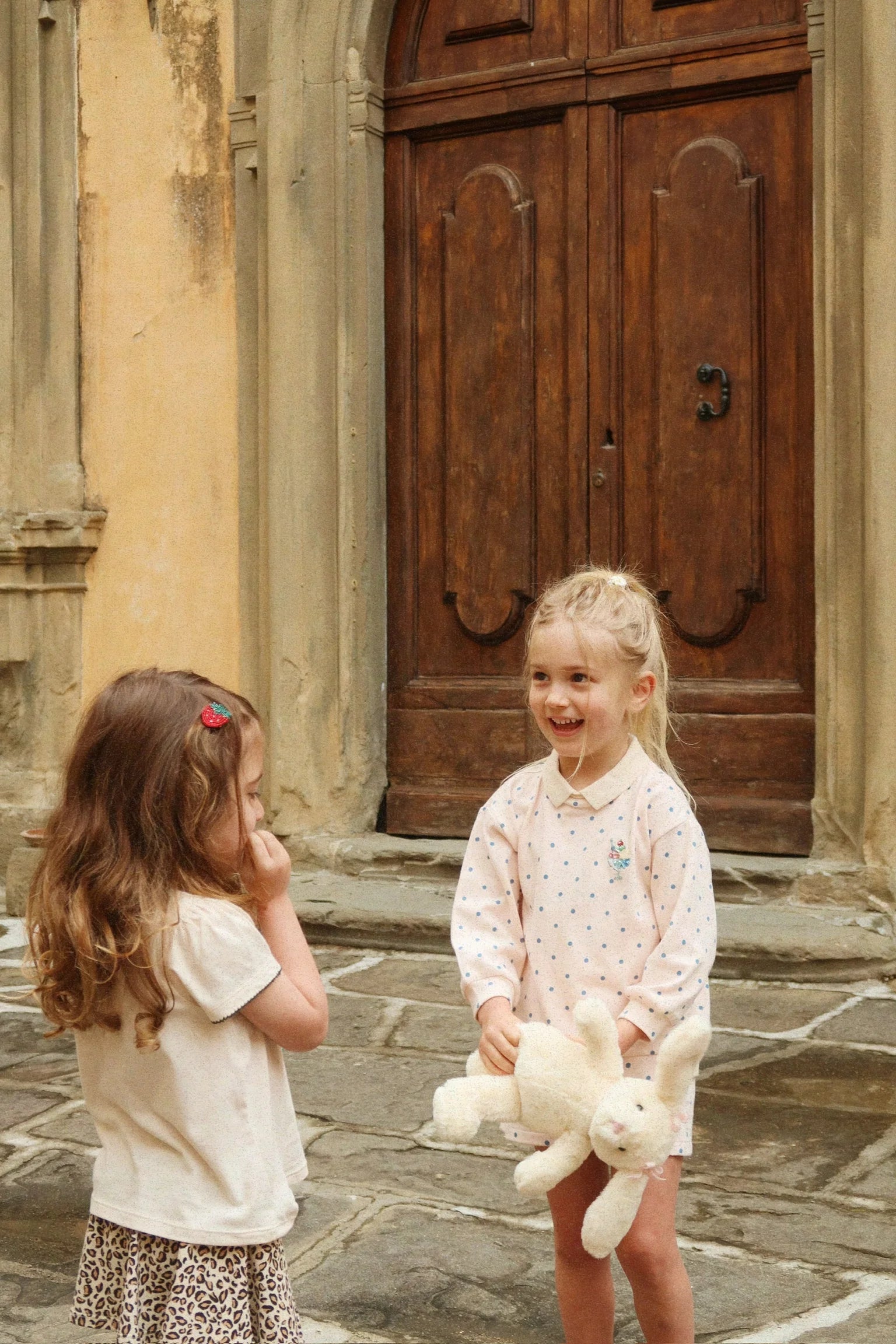 Kids wearing Konges Sløjd spotty long sleeve polo outdoors