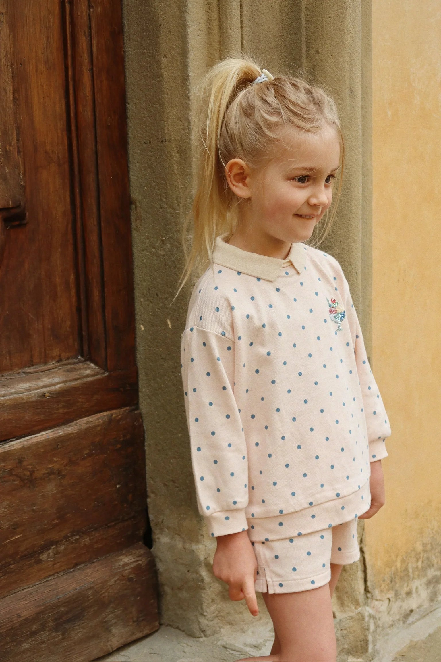Child wearing Konges Sløjd spotty sweat shorts, Scandinavian kidswear summer outfit
