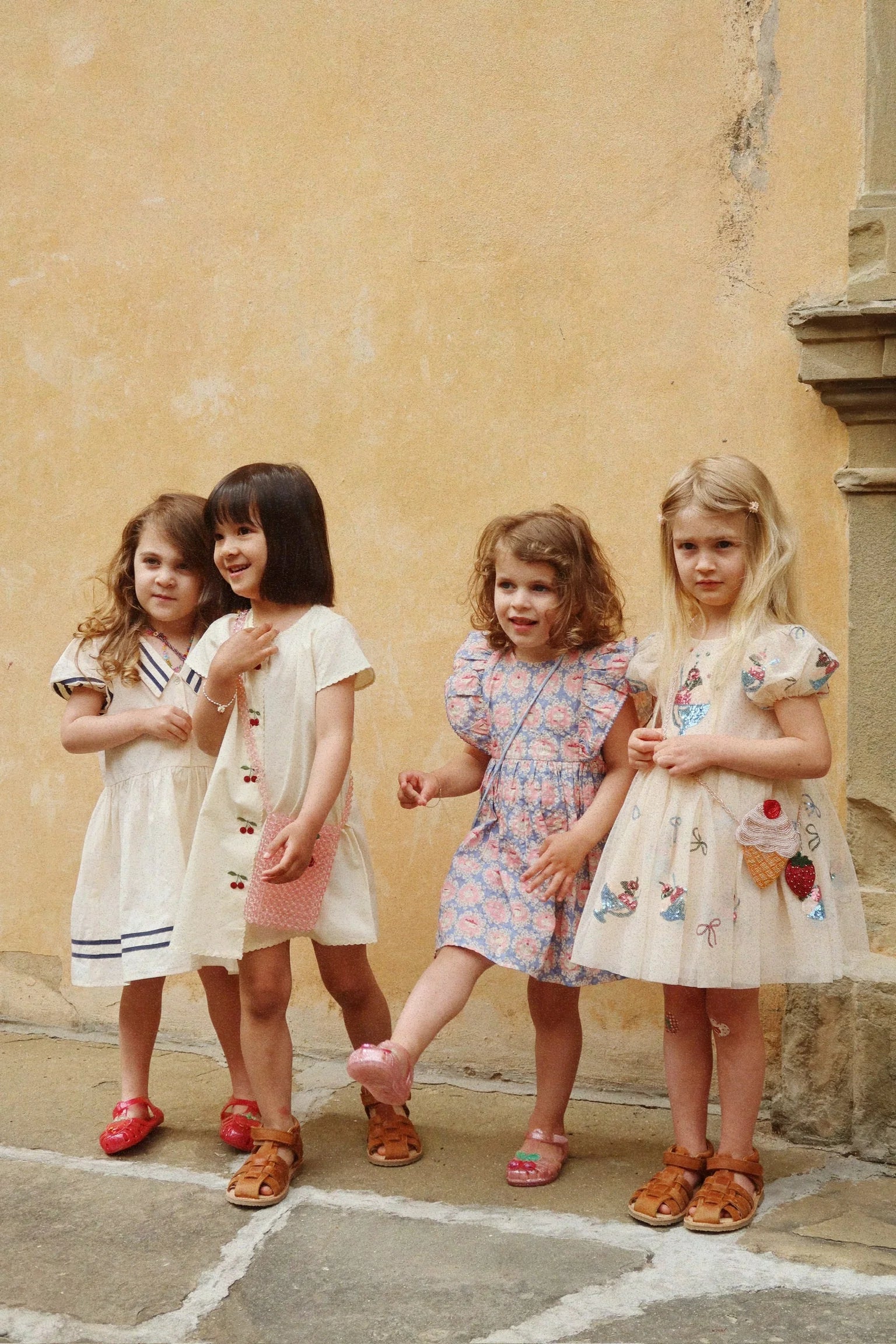 Children wearing Evia Cherry Dress by Konges Sløjd outdoors, matching toddler dresses with cherry print