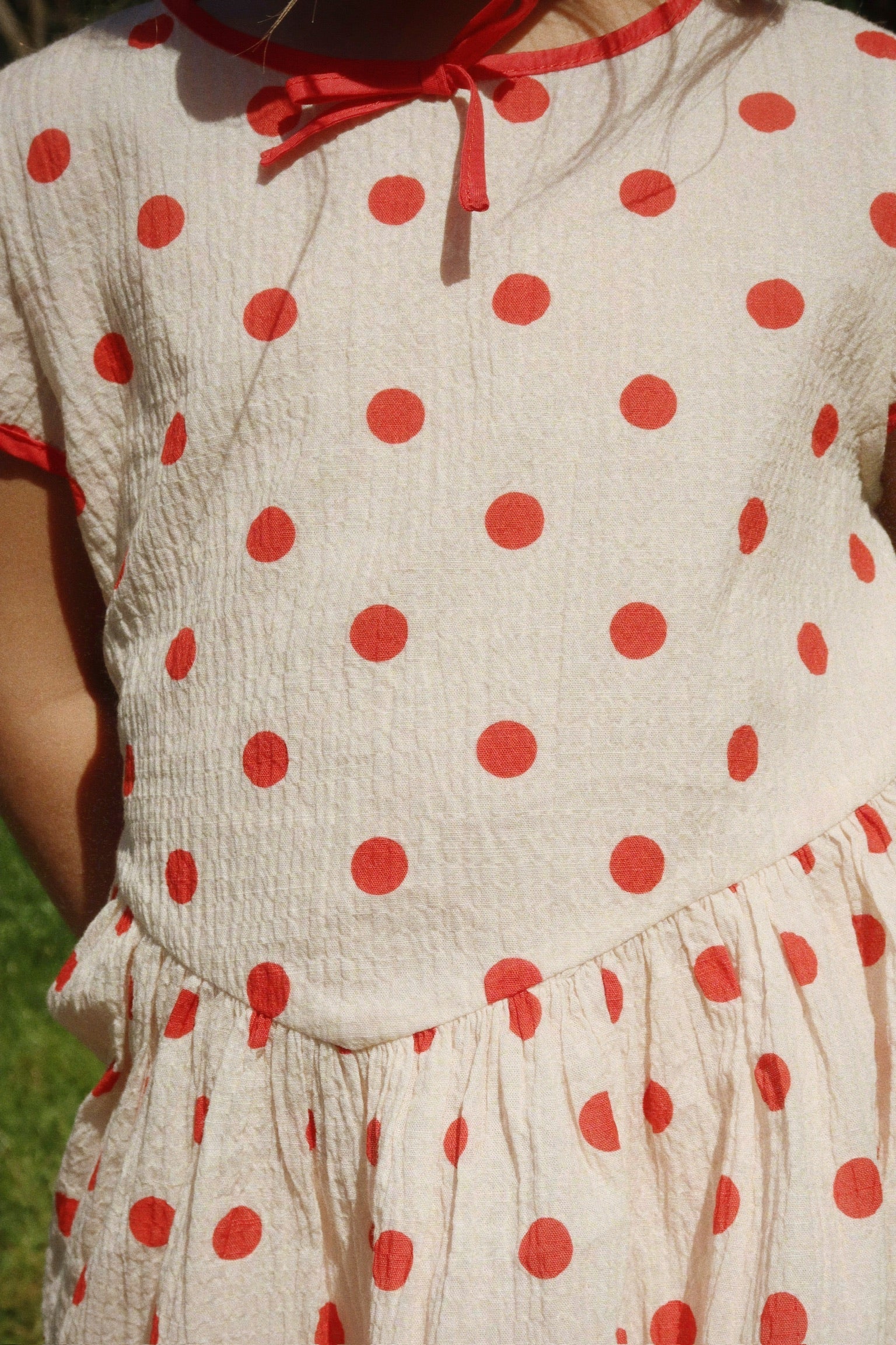 Close-up of Vivo Dress polka dot fabric by Konges Sløjd, soft cotton for baby skin