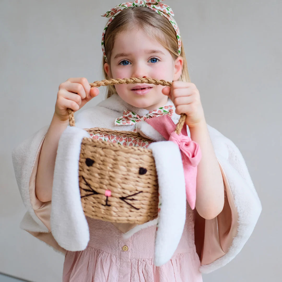 child holding Mimi and Lula bunny easter basket