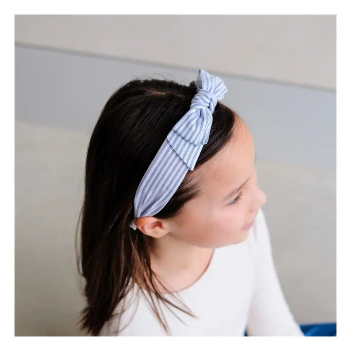 girl wearing Mimi and Lula pale blue striped knot headband