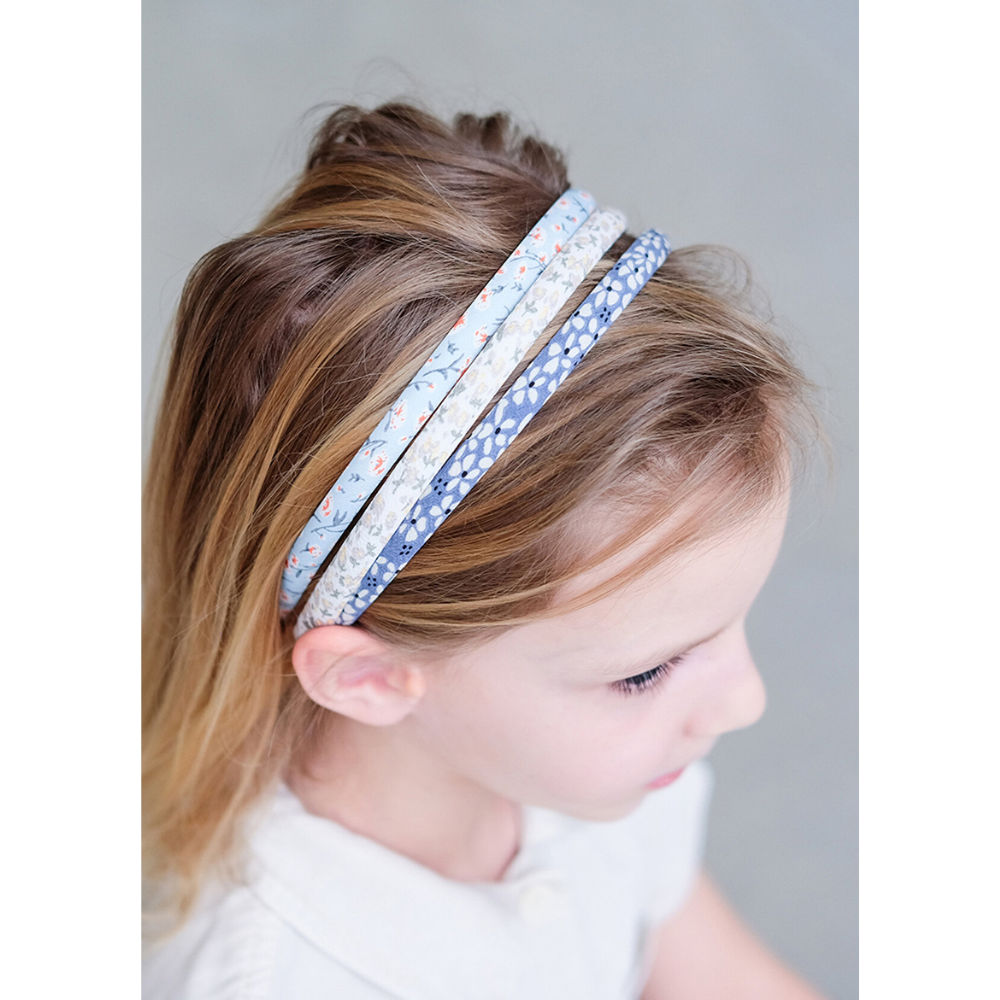 girl wearing Mimi and Lula tulip alice headband