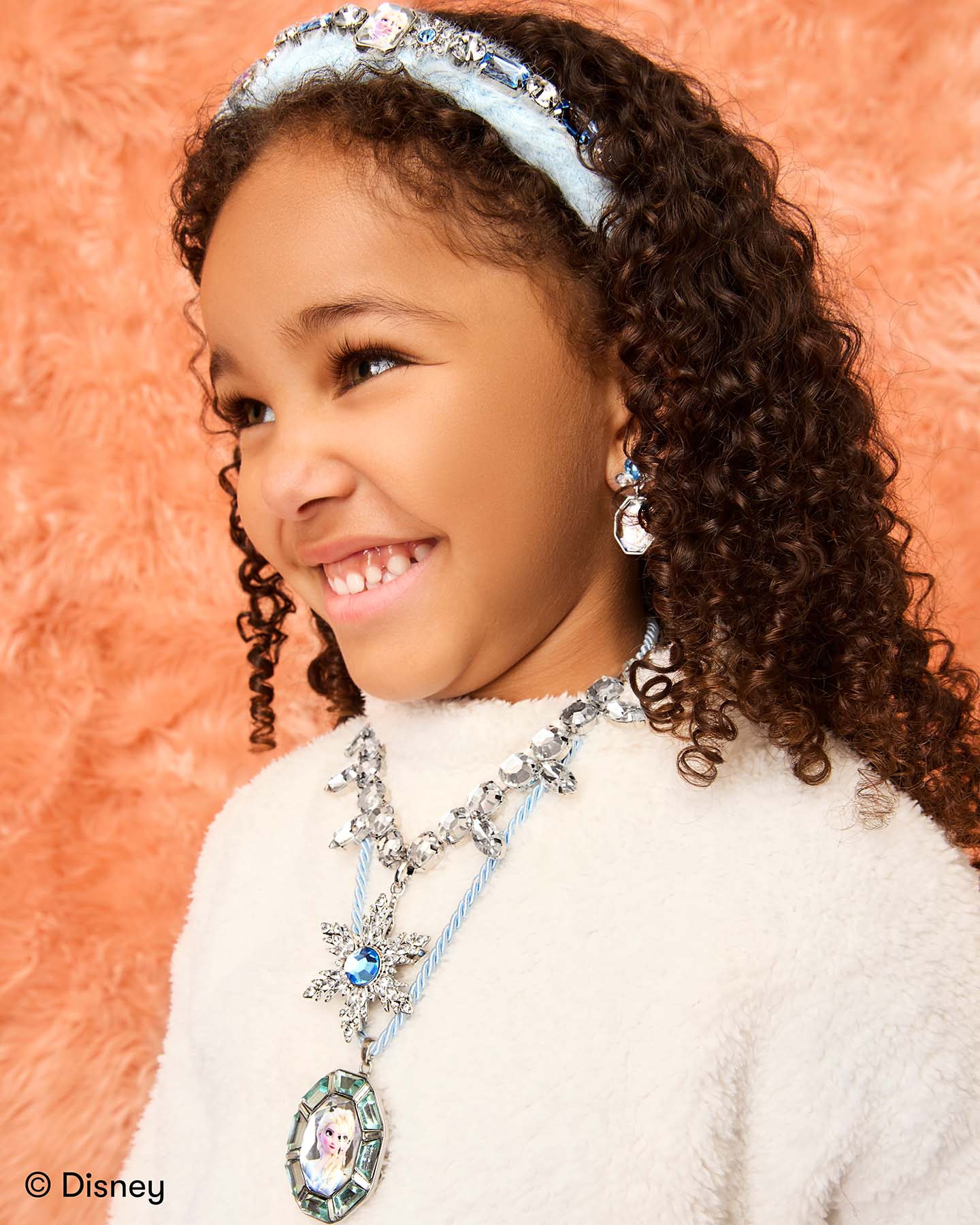 Child wearing Disney Frozen Earring Set with Disney-inspired accessories