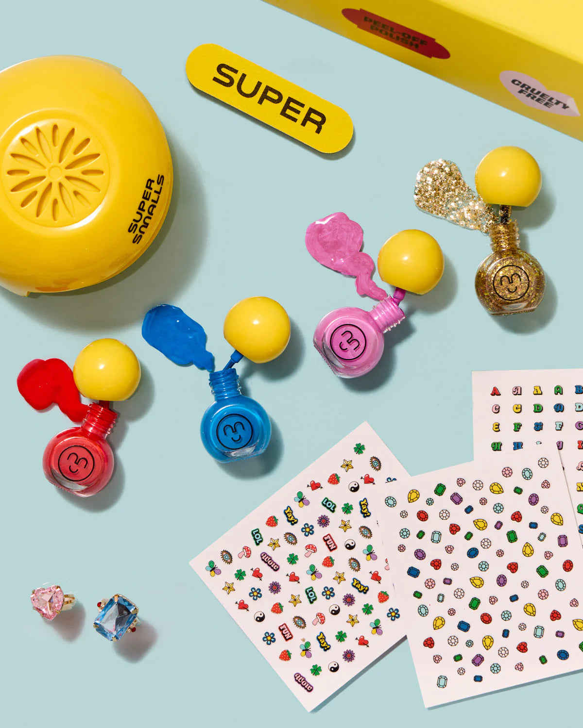 Super Smalls Self Care Nail Kit flat lay with nail accessories, stickers, and colorful beauty play items