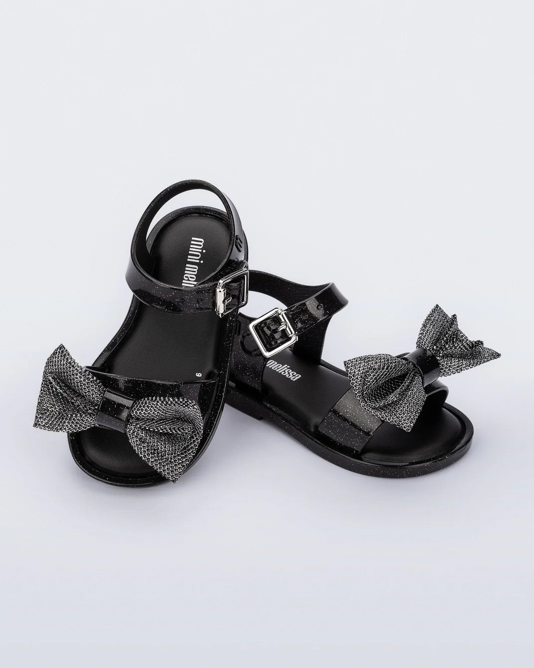 Mini Melissa Mar Sandal Sweet in Black — black kids jelly sandal with bow detail, pair shown on white background