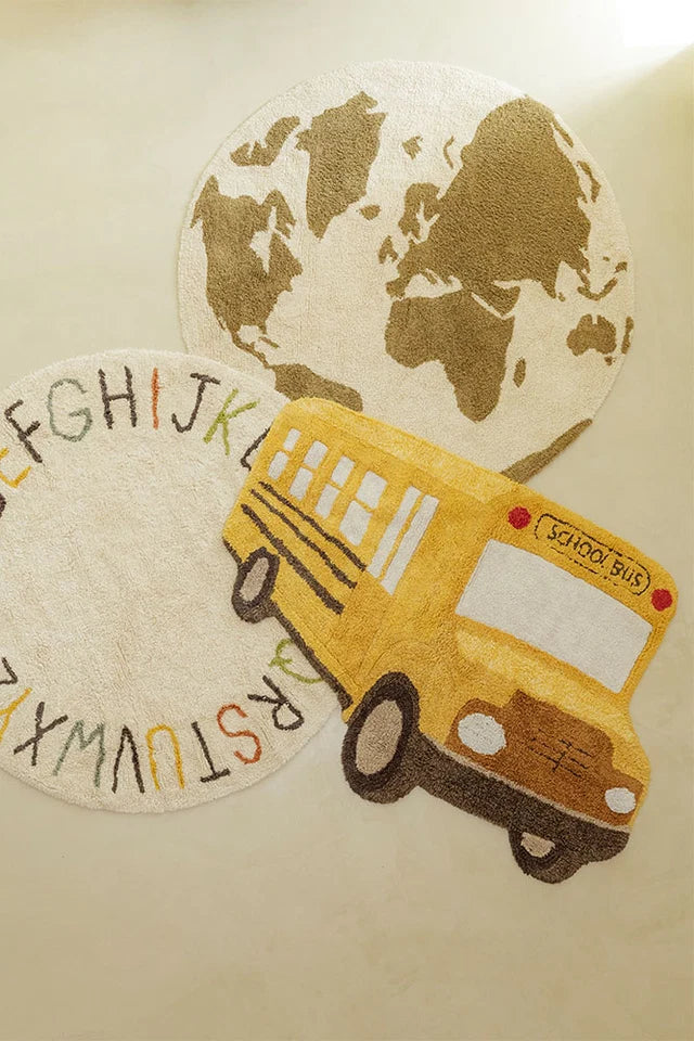 Washable Rug School Bus by Lorena Canals shown at scale in a nursery