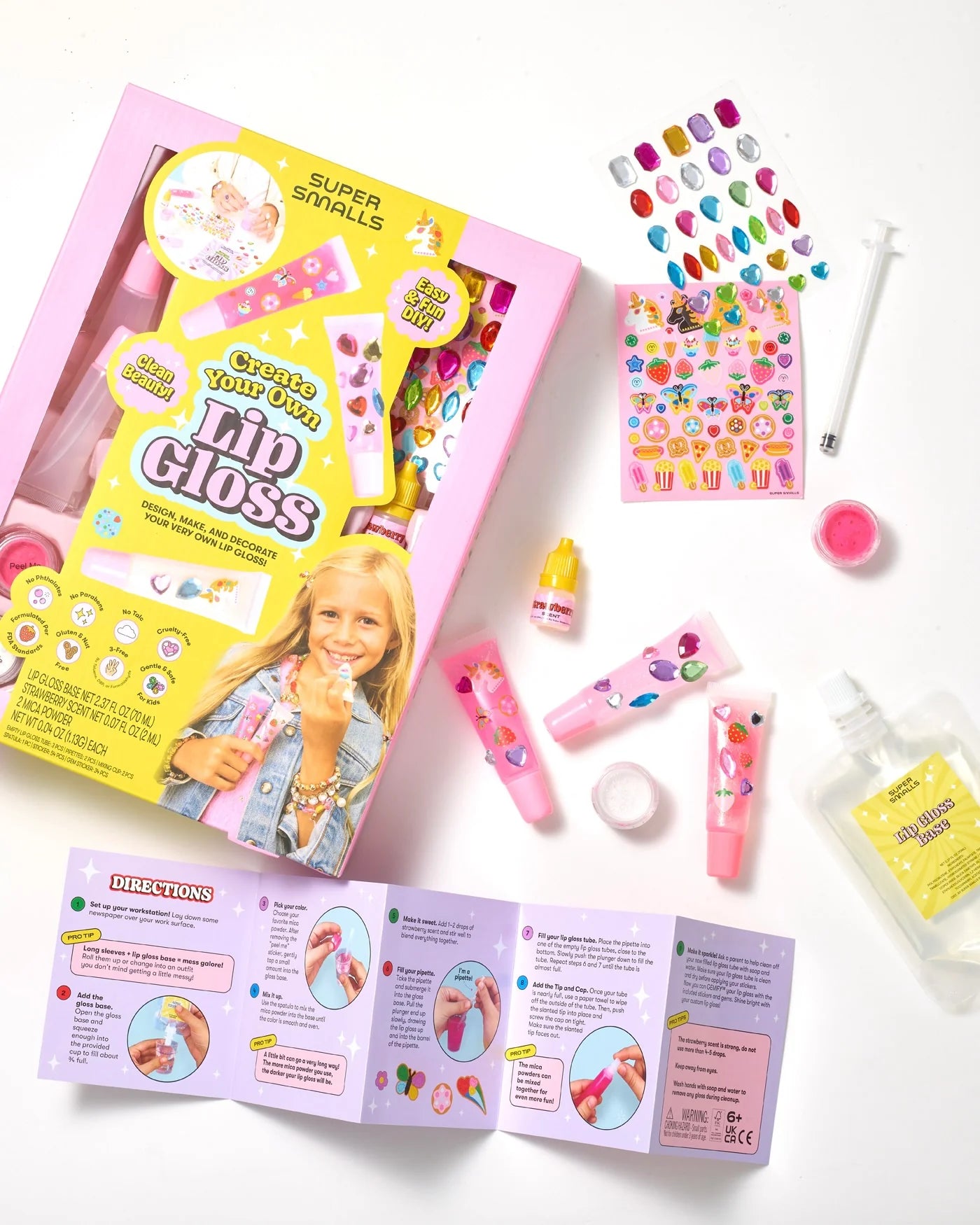 Supersmalls Create Your Own Lip Gloss kit — kids DIY lip gloss making set in pink tones, shown in gift box with mixing tools and accessories