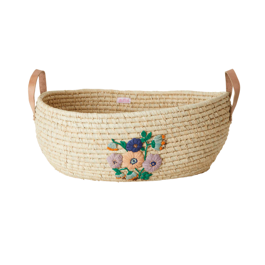 Handcrafted raffia oval basket by riceby rice with embroidered flowers
