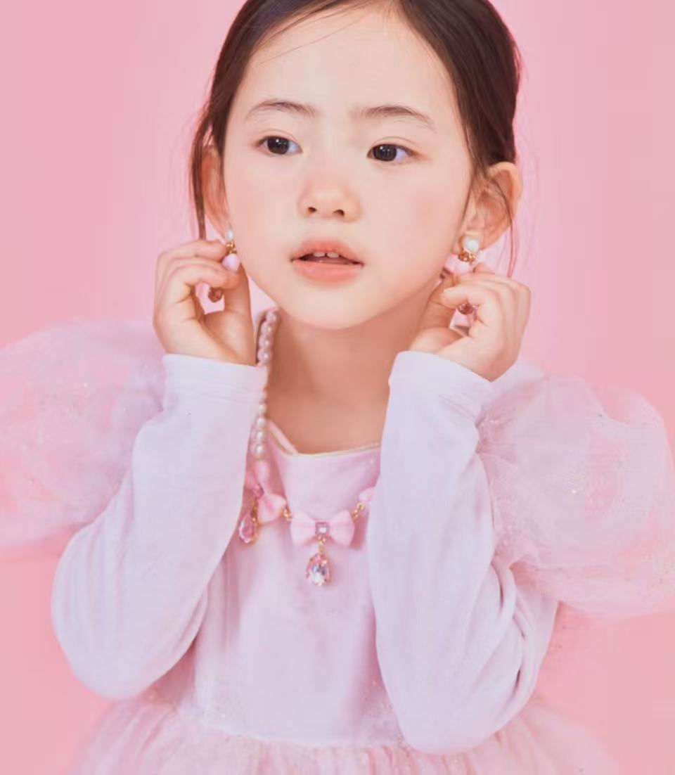 RuruStar Pink Bow Clip-On Earrings — lifestyle shot of pink bow clip-on earrings worn showing size and style