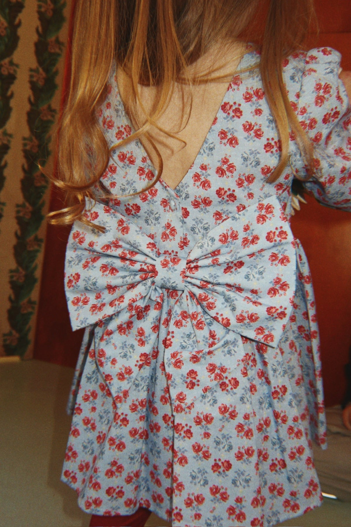 Girl wearing Konges Sløjd Avi LS Bow Dress in Lumina Blu