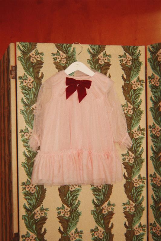 Girl wearing Konges Sløjd Bow Dress in Creole Pink