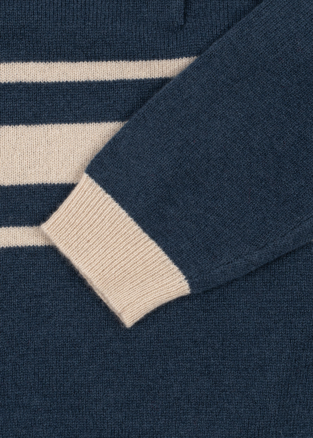 Close-up of the cream striped rib cuff on the navy wool polo