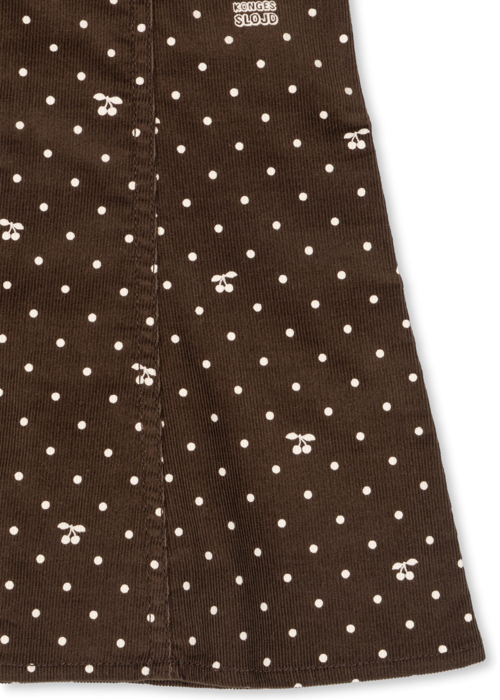 Close-up of the skirt and white dot print on the chocolate organic cotton dress