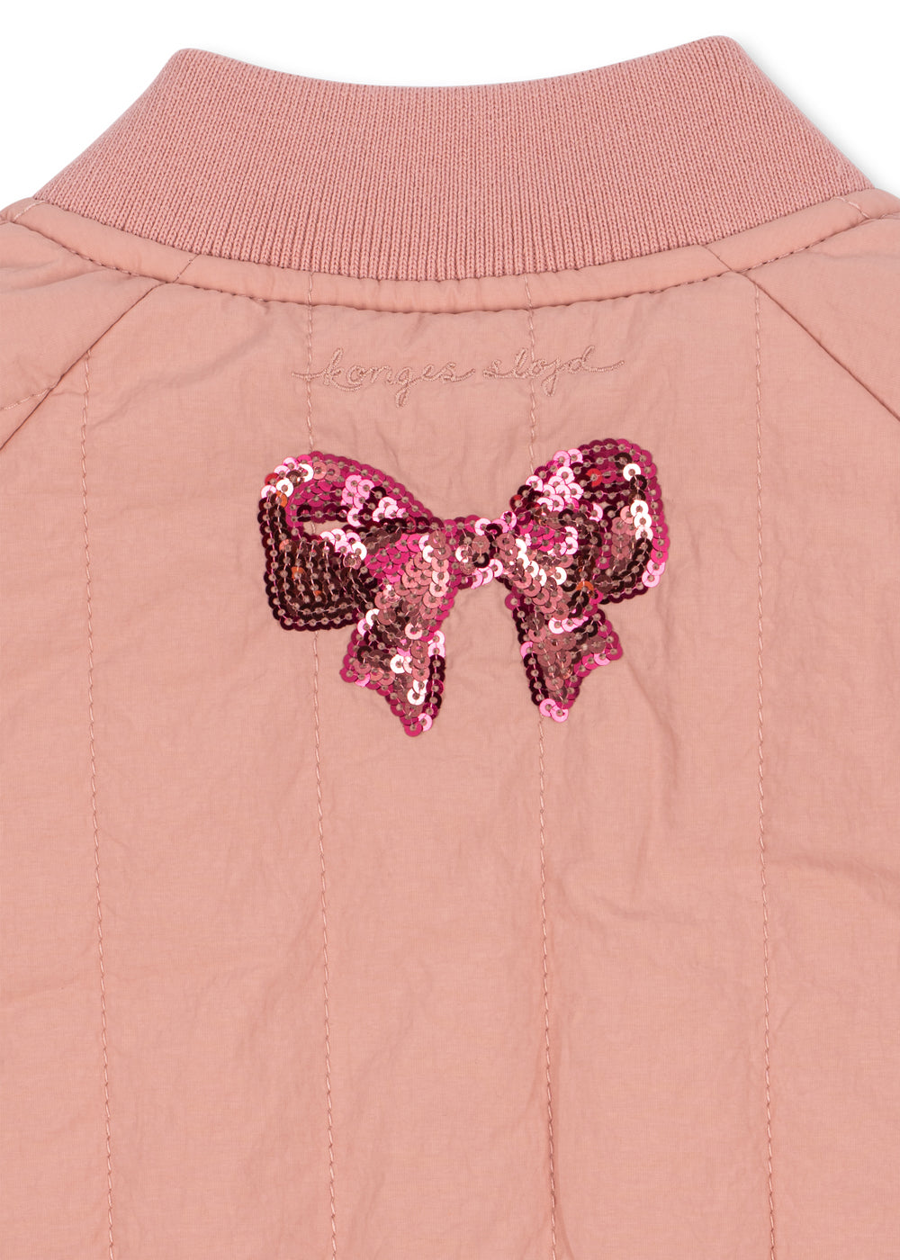 Close-up of the sequin bow and ribbed collar on the back of the jacket