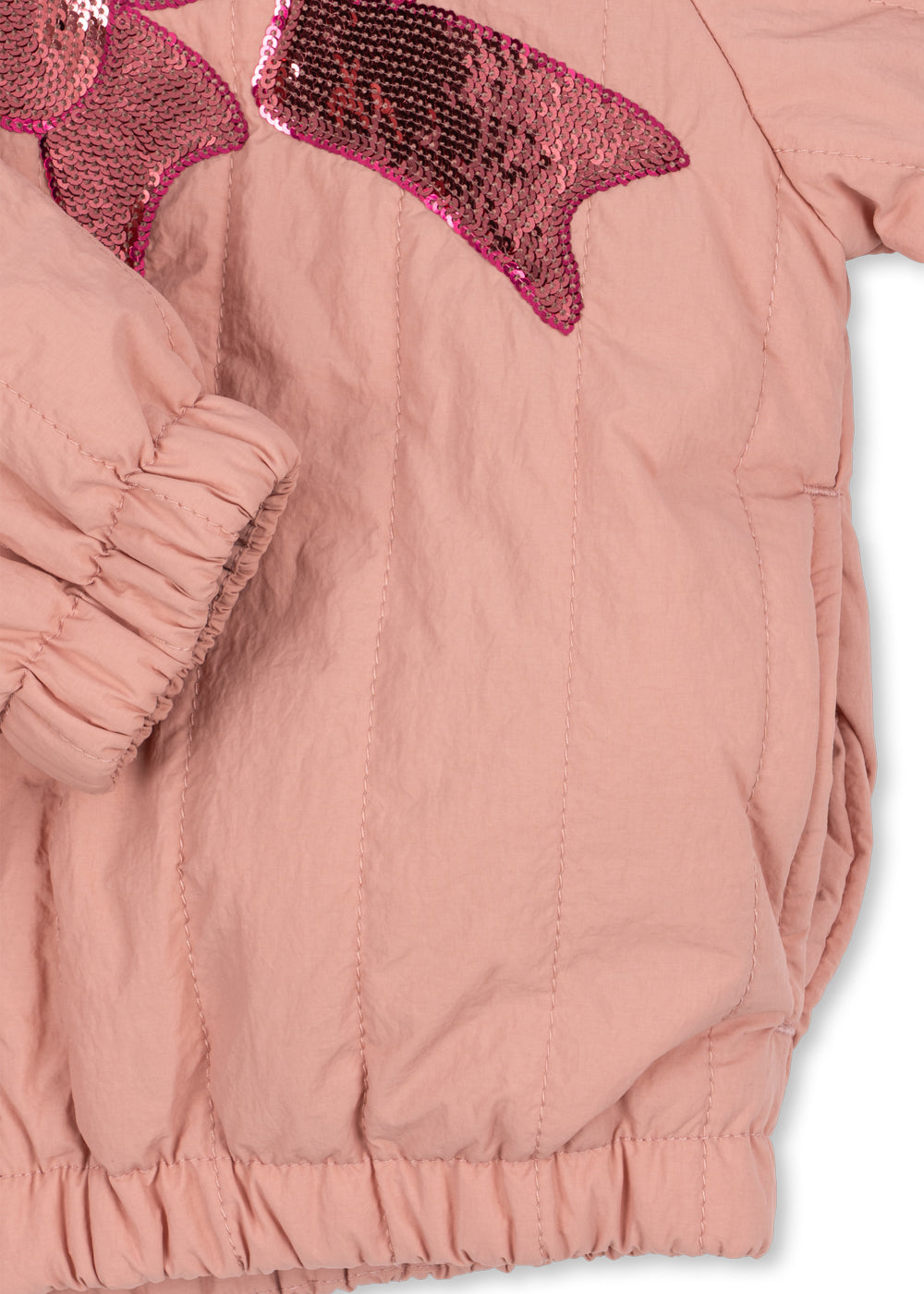 Close-up of the elasticated cuff and hem on the rosette sequin bomber