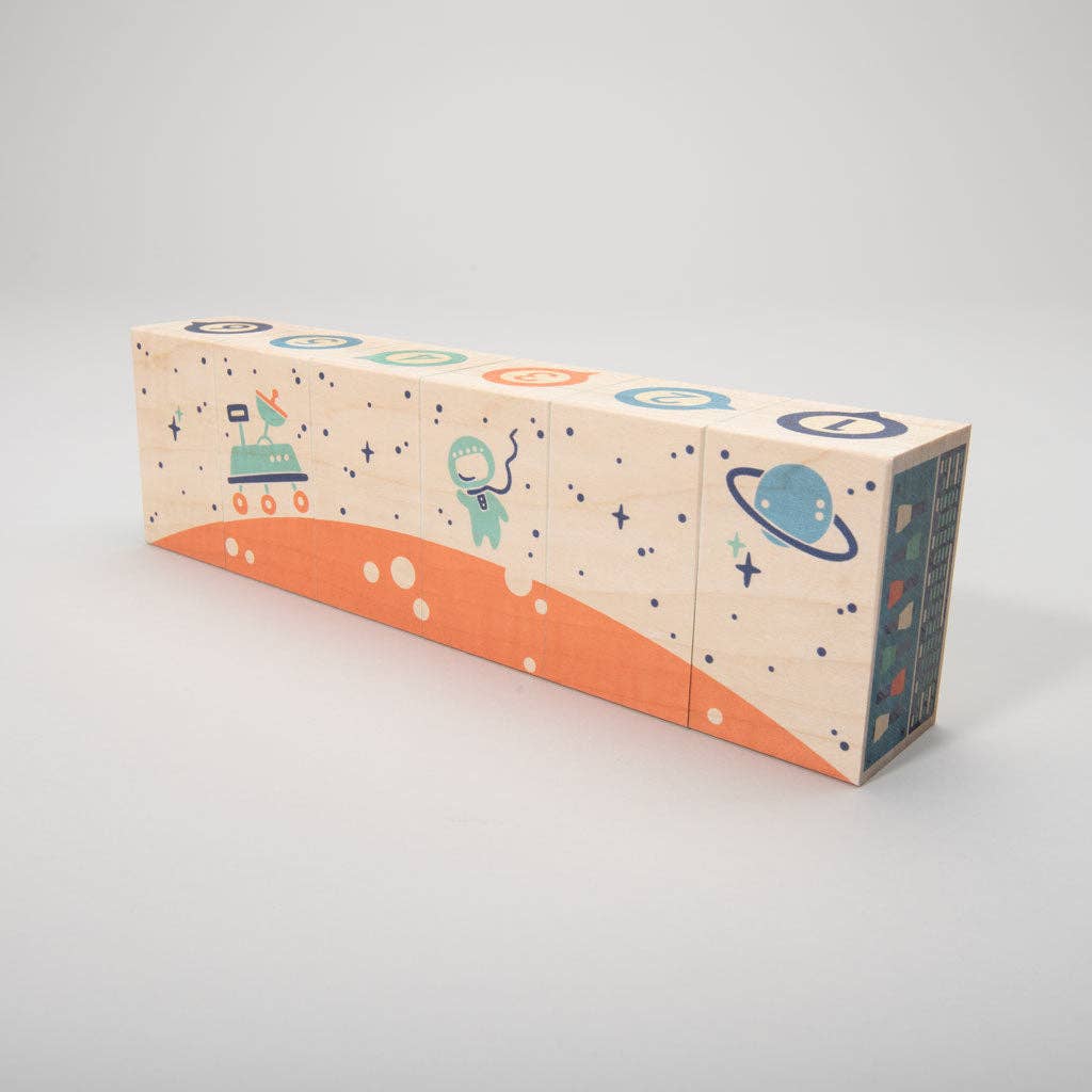 Close-up of space-themed wooden blocks showing a control panel design