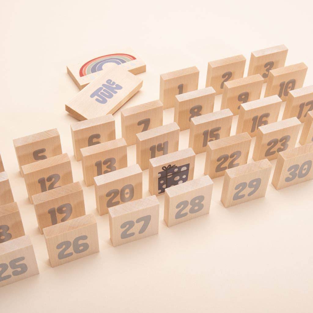 Close-up of square wooden number chips from the Uncle Goose calendar set