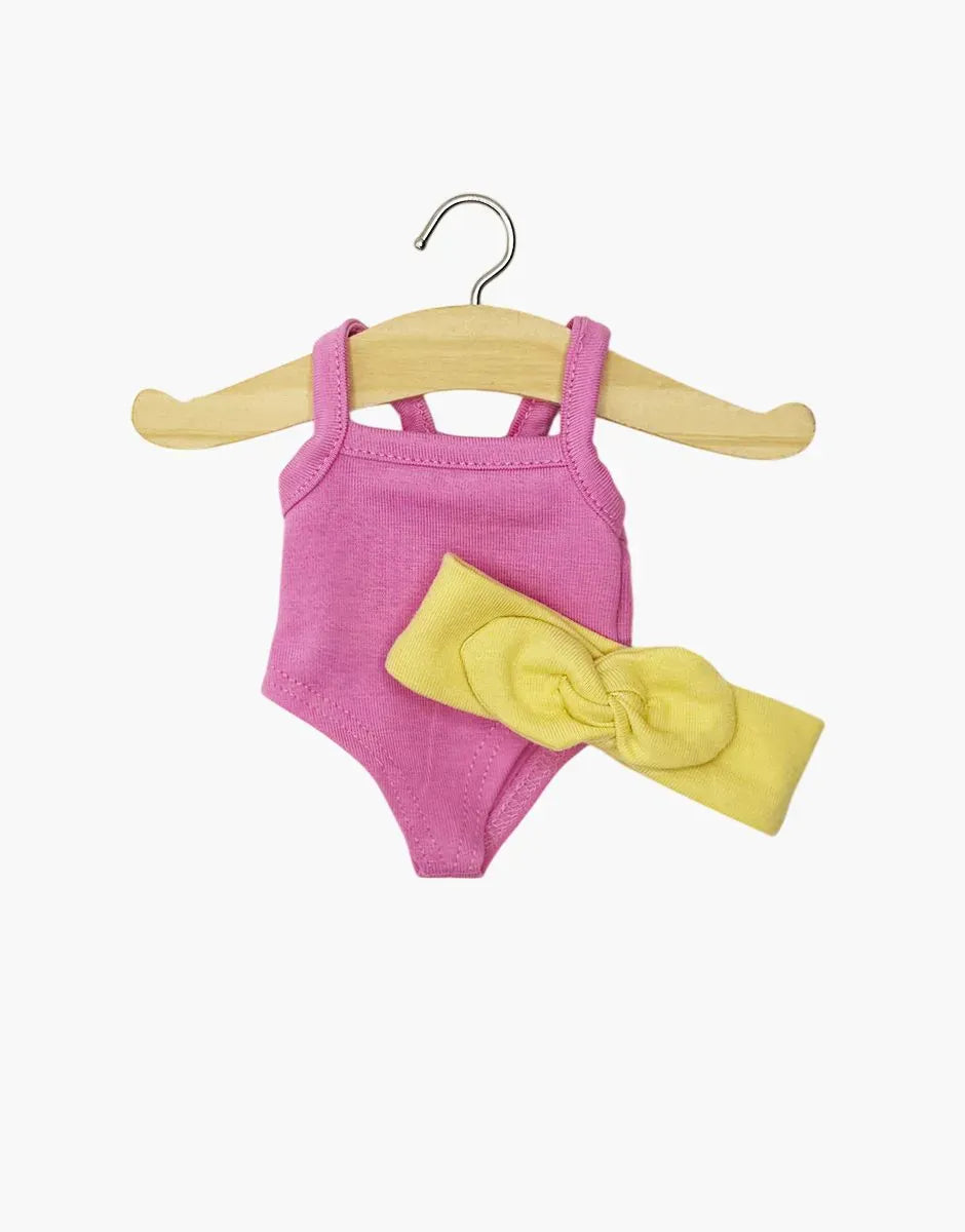 Mini Panchas candy pink bodysuit with vanilla yellow headband by Minikane