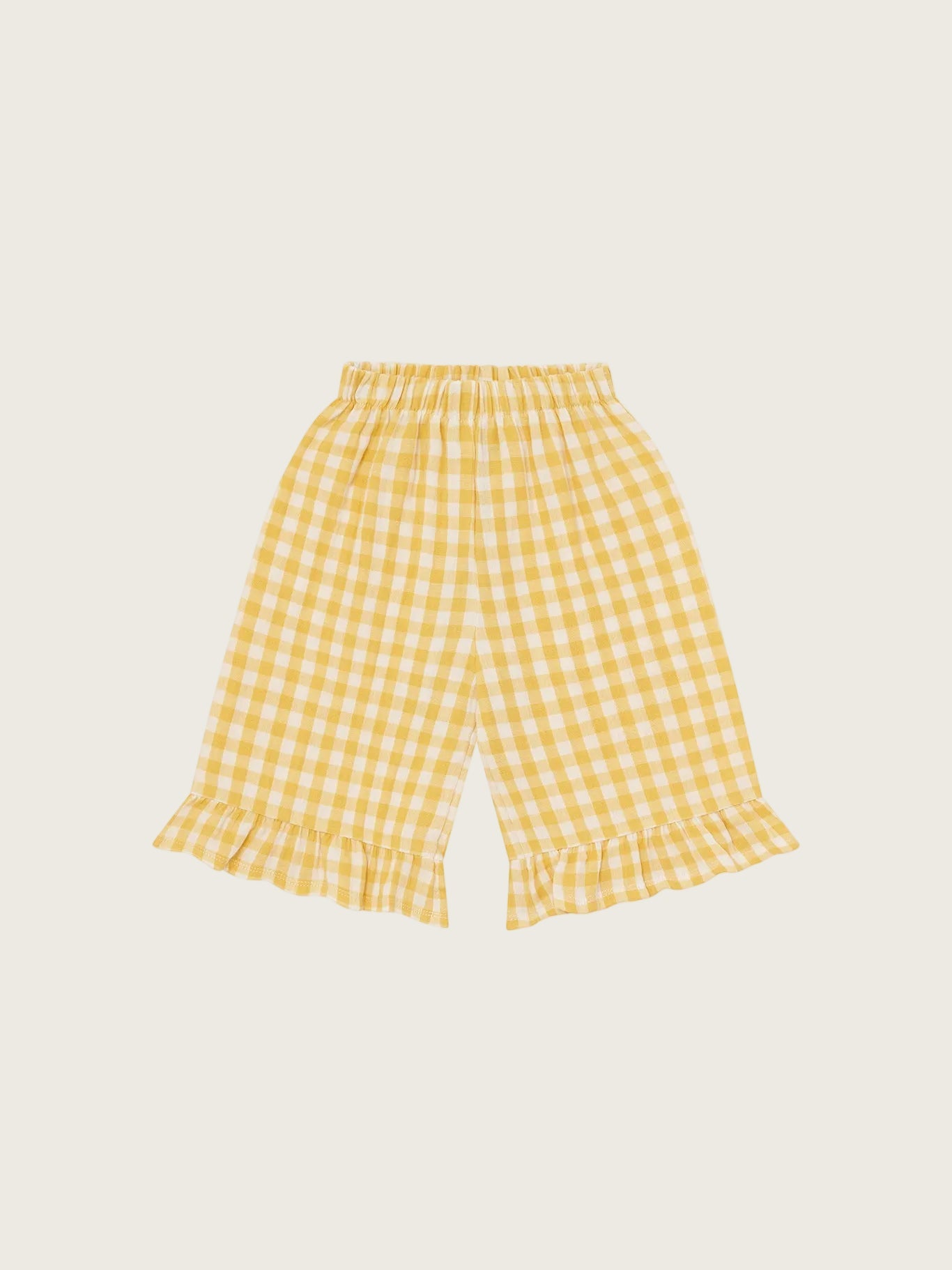 Organic Zoo Honeycomb Gingham Frill Culottes — loose fit organic muslin kids culottes with frill trim and warm honeycomb gingham print, flat lay on cream background